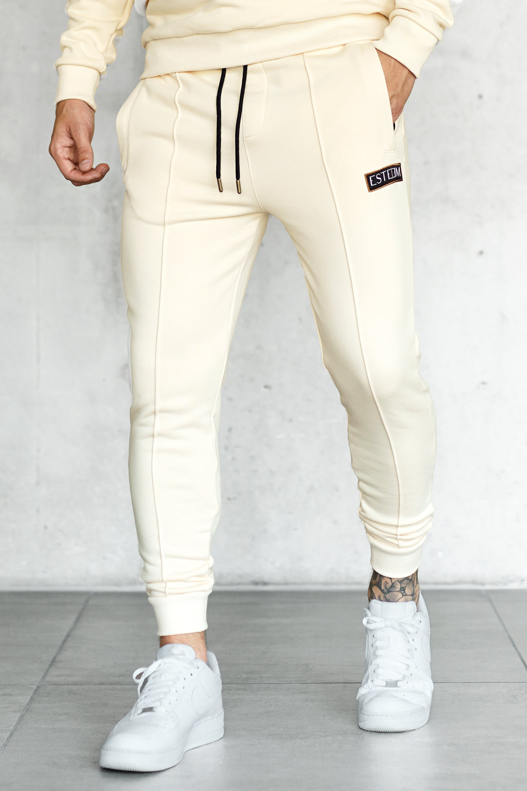 BEIGE PATCH SWEATPANTS